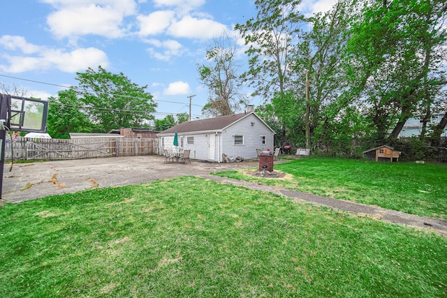 view of yard featuring a shed and a patio