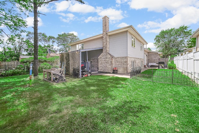 rear view of property featuring a lawn