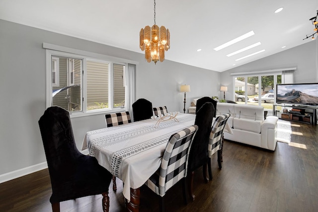 dining room with dark hardwood / wood-style flooring, lofted ceiling with skylight, and an inviting chandelier