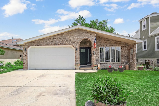 view of front of home with a front lawn and a garage