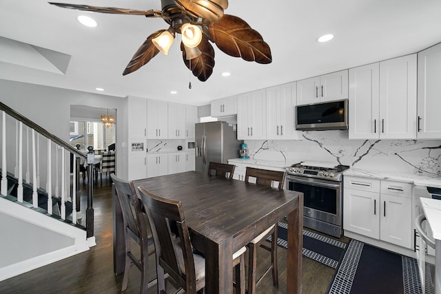 kitchen featuring white cabinets, appliances with stainless steel finishes, and tasteful backsplash