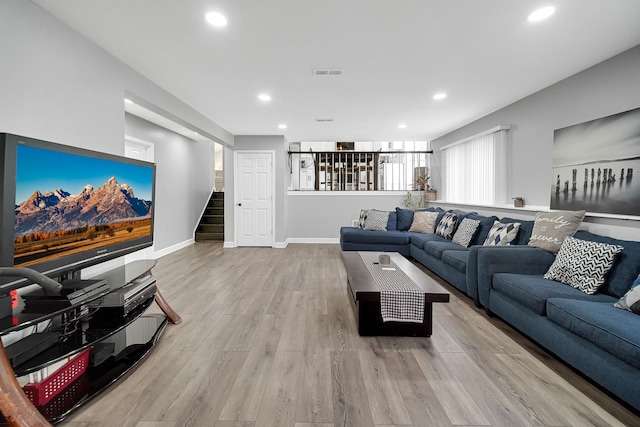 living room featuring plenty of natural light and light wood-type flooring