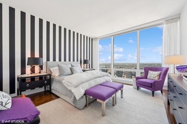 bedroom featuring hardwood / wood-style flooring and floor to ceiling windows