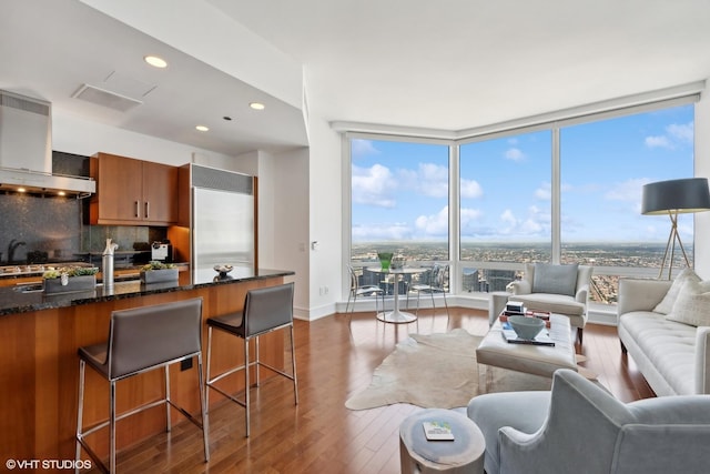 living room featuring expansive windows and dark hardwood / wood-style flooring