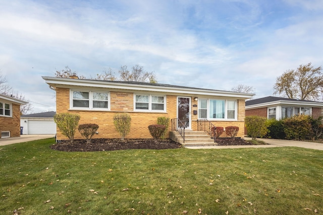single story home featuring a front lawn, brick siding, an outbuilding, and a detached garage
