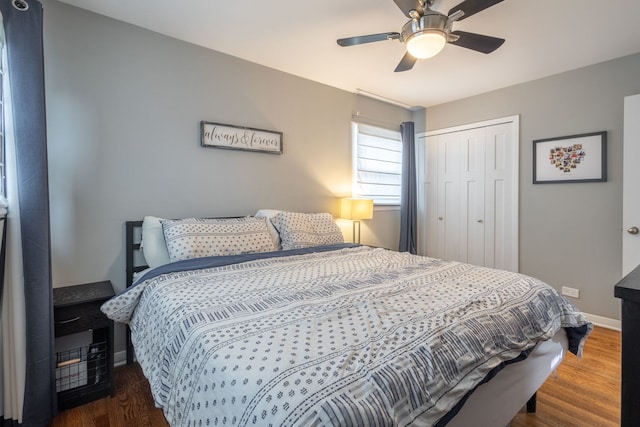 bedroom featuring baseboards, a closet, ceiling fan, and wood finished floors