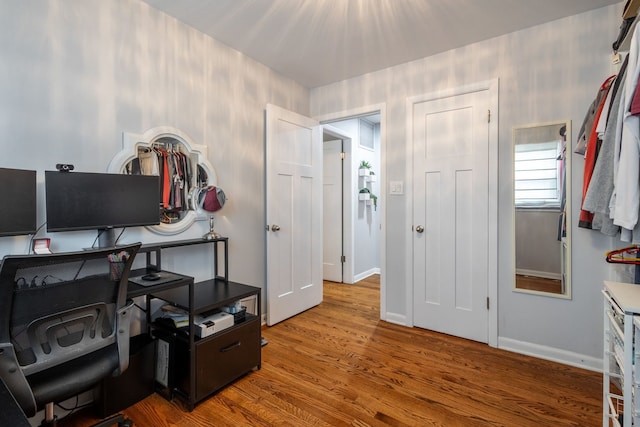 office area with baseboards and wood finished floors