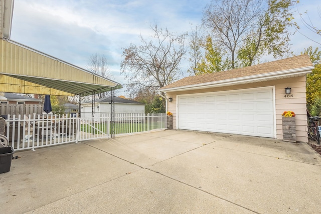 detached garage featuring fence