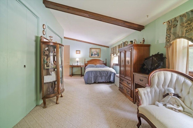 bedroom with lofted ceiling with beams, multiple windows, and light colored carpet