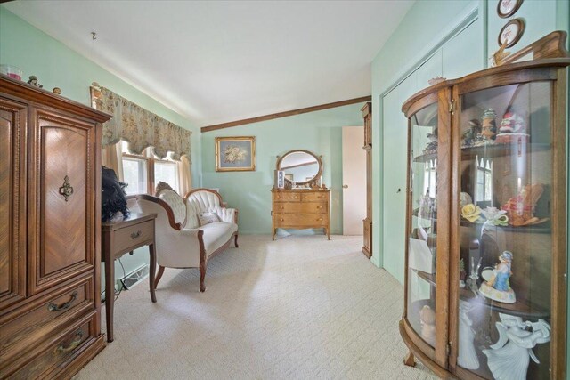 sitting room featuring light colored carpet and lofted ceiling