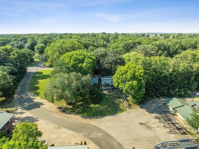 birds eye view of property featuring a wooded view