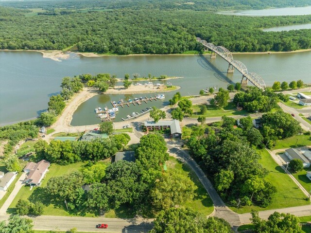 aerial view featuring a wooded view and a water view