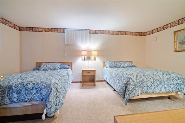 carpeted bedroom featuring baseboards