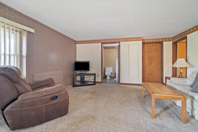 living room with baseboards, brick wall, and carpet flooring