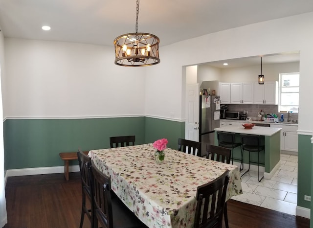 dining room featuring recessed lighting, baseboards, and a chandelier