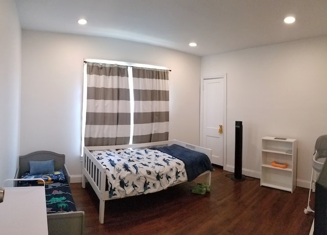 bedroom with recessed lighting, wood finished floors, and baseboards