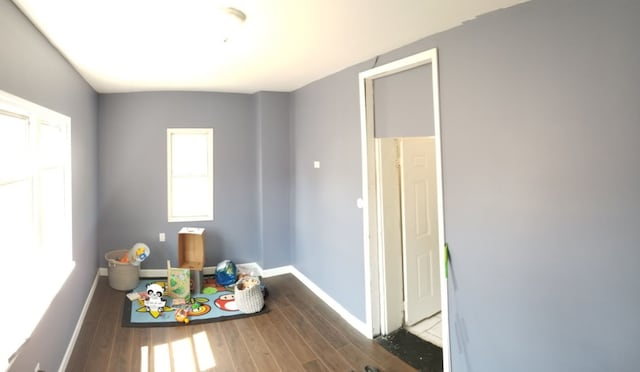 game room featuring dark wood finished floors and baseboards