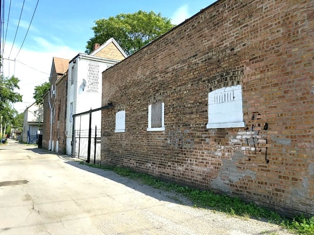 view of side of home with brick siding