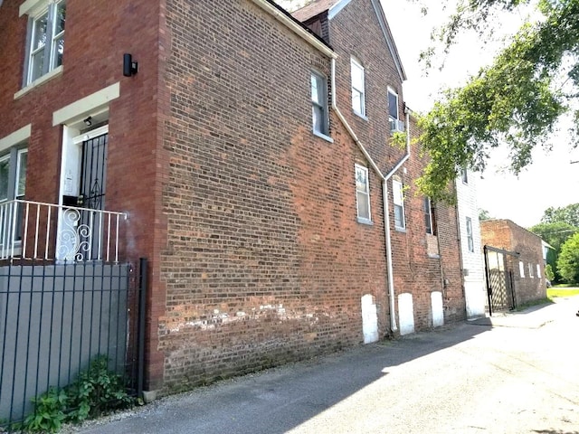 view of side of property with a garage and brick siding