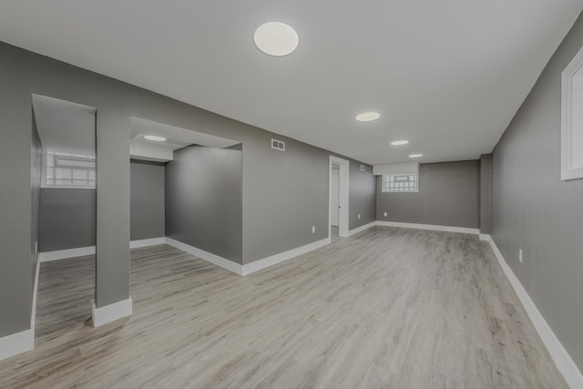 basement with light hardwood / wood-style floors