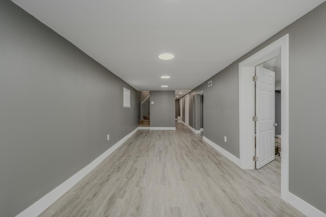 basement with light hardwood / wood-style flooring