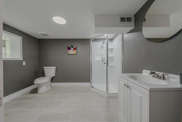 bathroom featuring tile patterned floors, vanity, toilet, and walk in shower