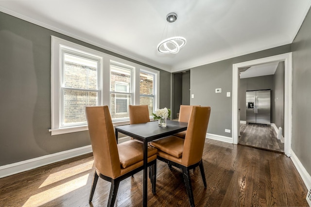 dining space featuring a wealth of natural light, an inviting chandelier, dark hardwood / wood-style floors, and ornamental molding