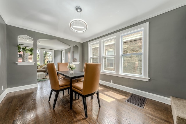 dining room featuring wood-type flooring and ornamental molding