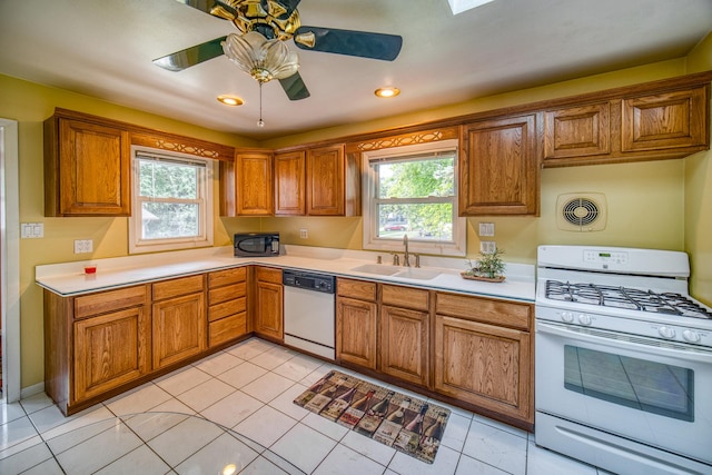 kitchen with ceiling fan, light tile patterned flooring, white appliances, and sink