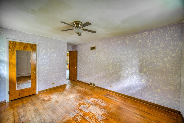 empty room featuring ceiling fan and wood-type flooring