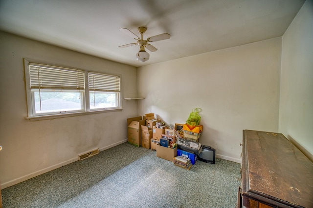 interior space with carpet flooring and ceiling fan