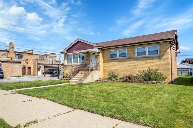 view of front of home with a garage and a front lawn