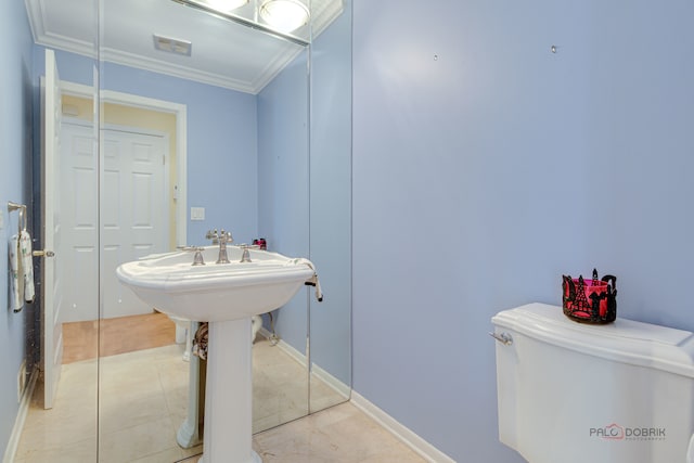 bathroom with ornamental molding, toilet, and tile patterned flooring