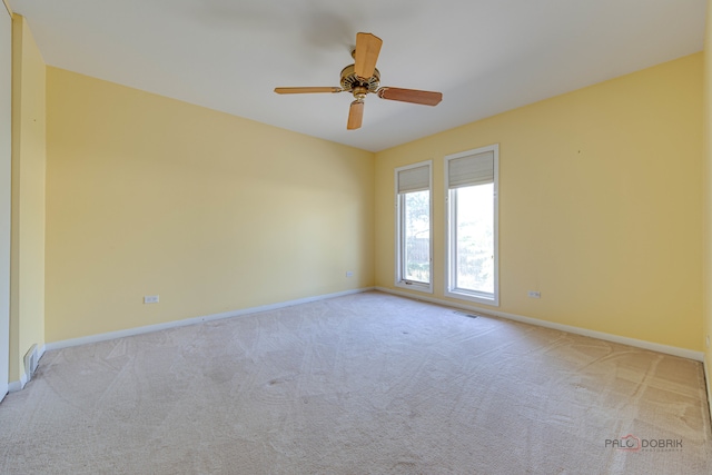 carpeted spare room with ceiling fan