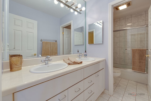 full bathroom with vanity, combined bath / shower with glass door, toilet, and tile patterned flooring