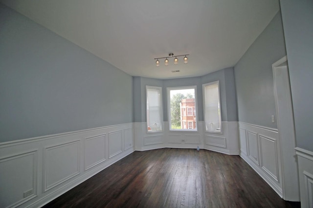 unfurnished dining area featuring dark wood-type flooring