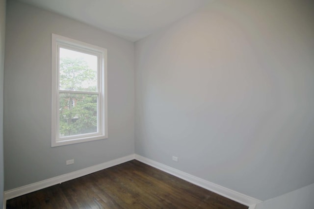 spare room with dark hardwood / wood-style floors