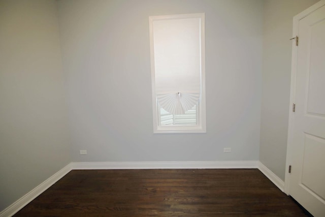 spare room featuring dark wood-type flooring