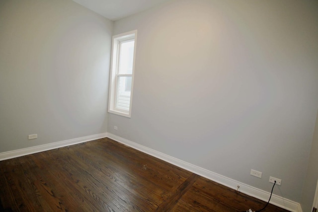 unfurnished room with dark wood-type flooring