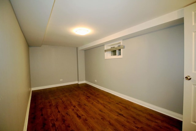 basement with dark hardwood / wood-style floors