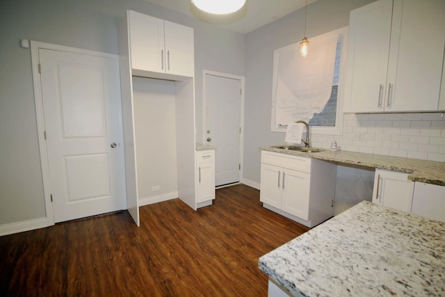 kitchen with white cabinetry, sink, tasteful backsplash, dark hardwood / wood-style flooring, and pendant lighting