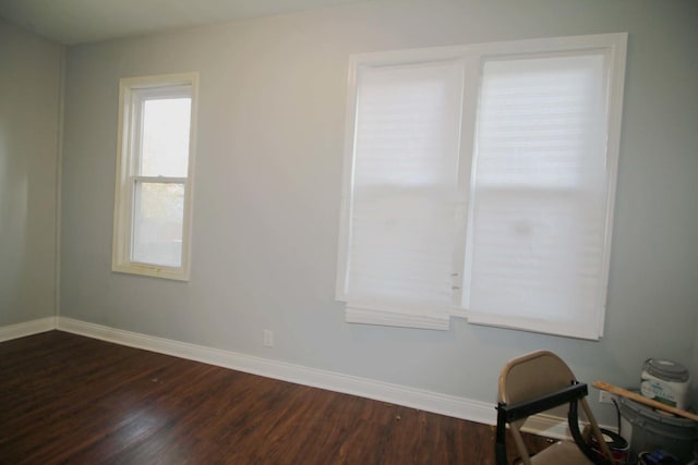 spare room featuring dark wood-type flooring