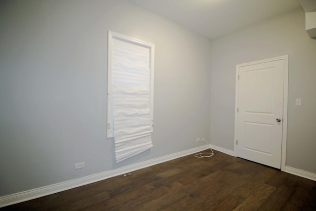 unfurnished room featuring dark wood-type flooring