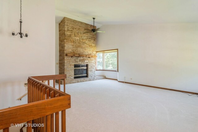 carpeted living room with high vaulted ceiling, a stone fireplace, and ceiling fan