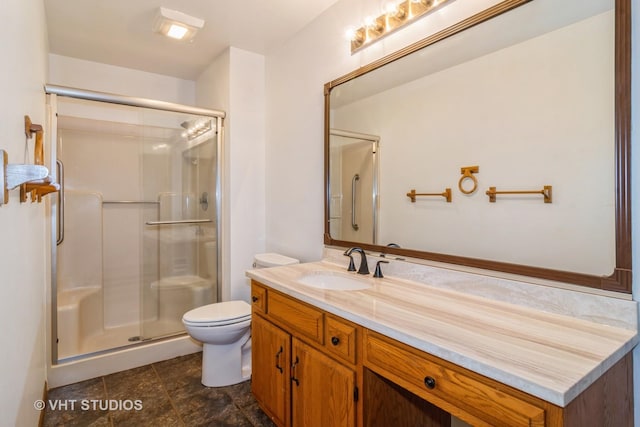 bathroom featuring toilet, vanity, and walk in shower