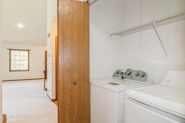 laundry room featuring washing machine and dryer and light carpet