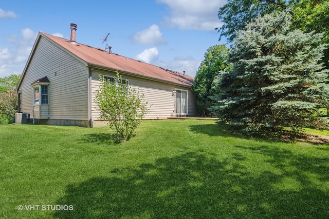 exterior space featuring a yard and central AC