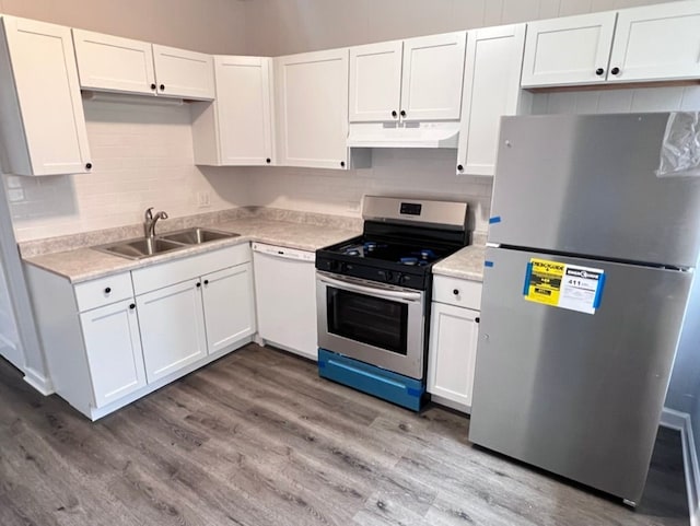 kitchen featuring sink, hardwood / wood-style flooring, stainless steel appliances, and white cabinets