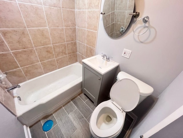 full bathroom with tiled shower / bath combo, vanity, and toilet