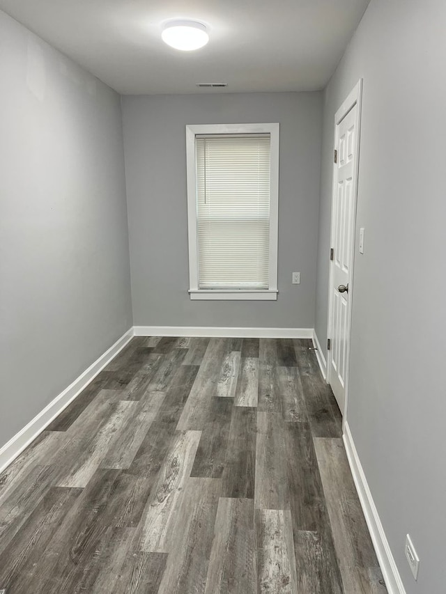 spare room with dark wood-type flooring